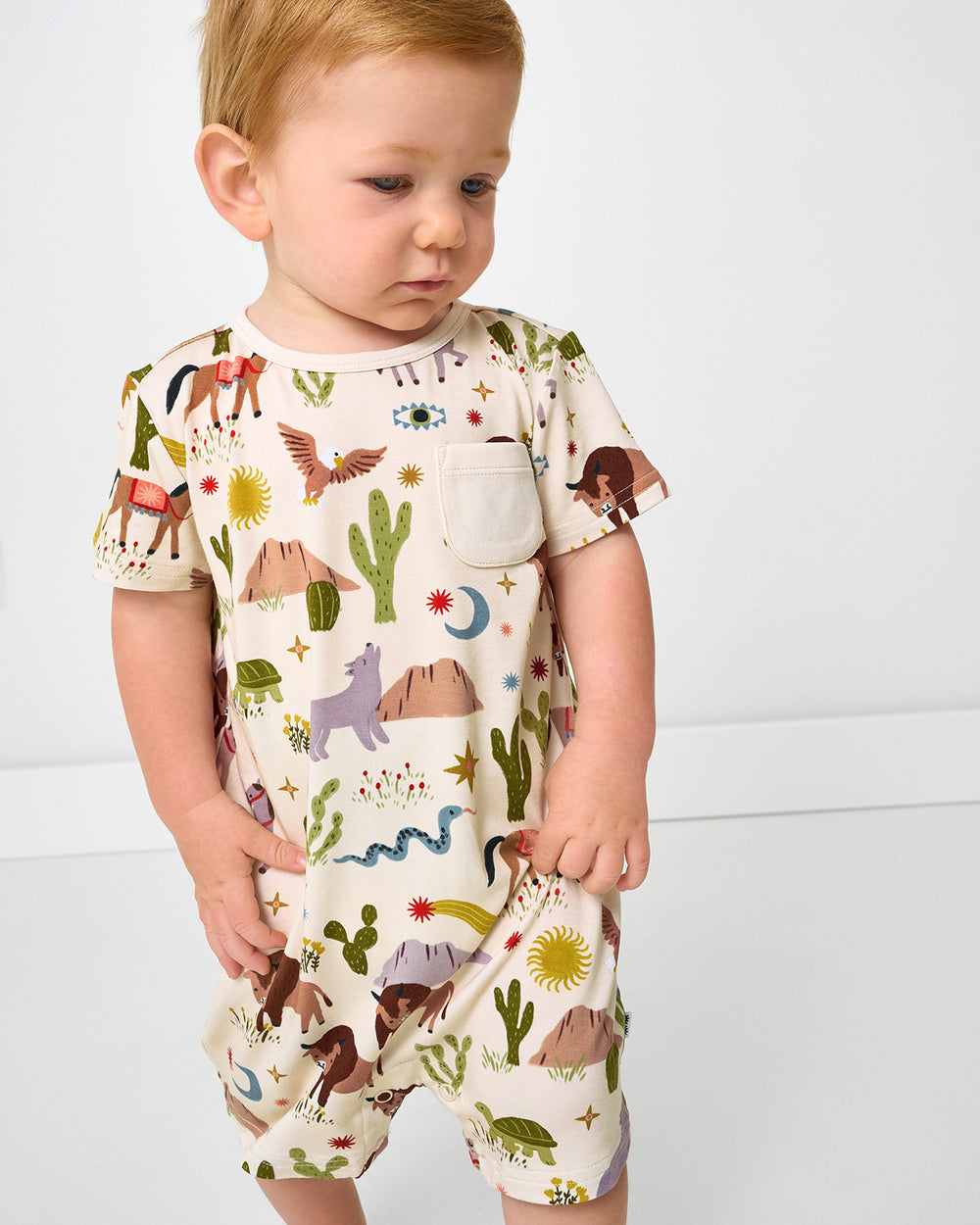 Close up of toddler wearing the Wild Frontier Pocket Shorty Romper
