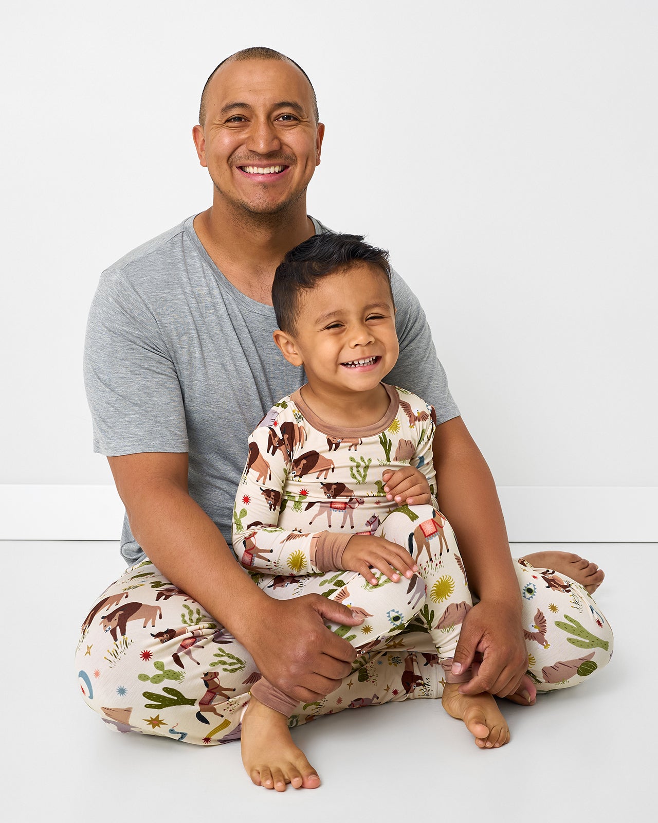 Father and son wearing matching Wild Frontier western themed pajamas