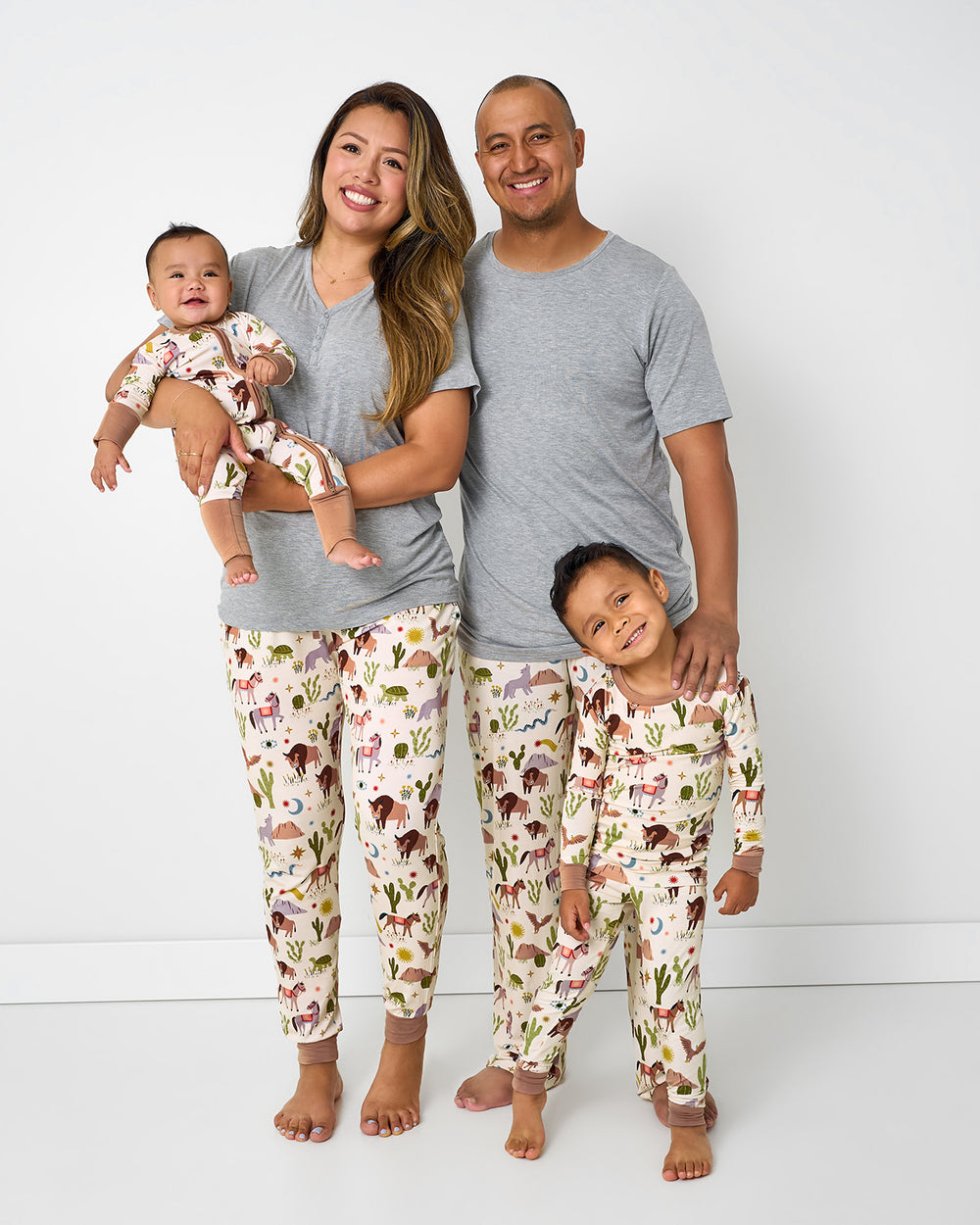 Family of four wearing matching Wild Frontier western themed pajamas