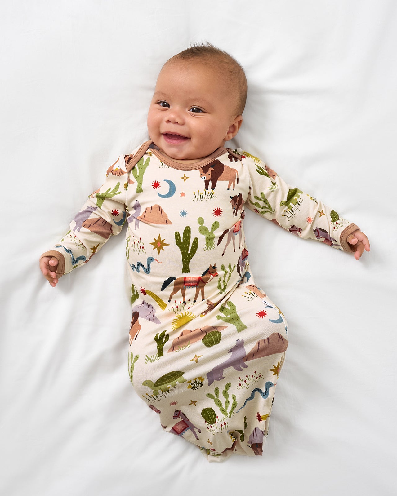 Alternate aerial view of baby wearing the Wild Frontier Infant Gown