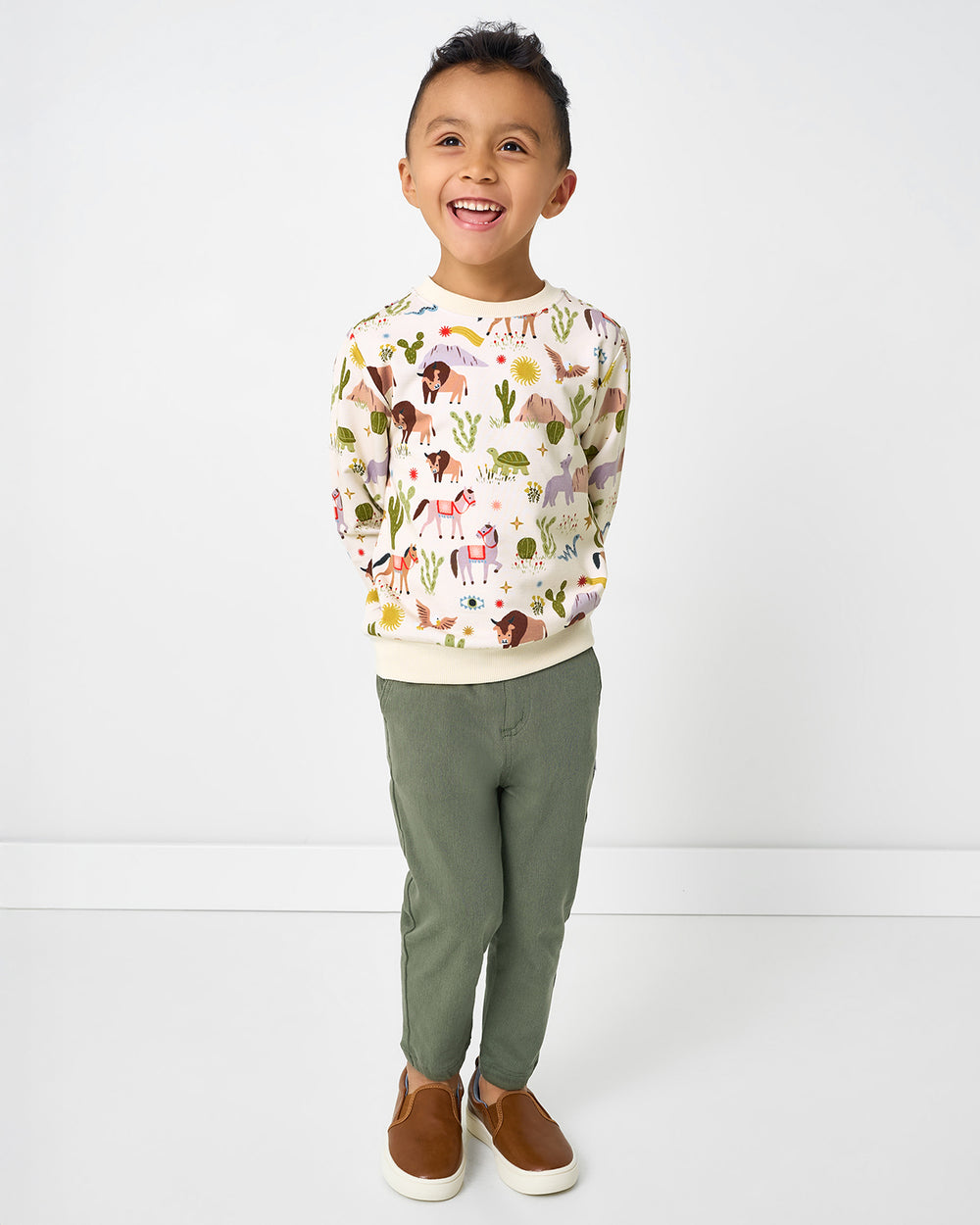 Boy wearing the Wild Frontier Crewneck Sweatshirt with green pants