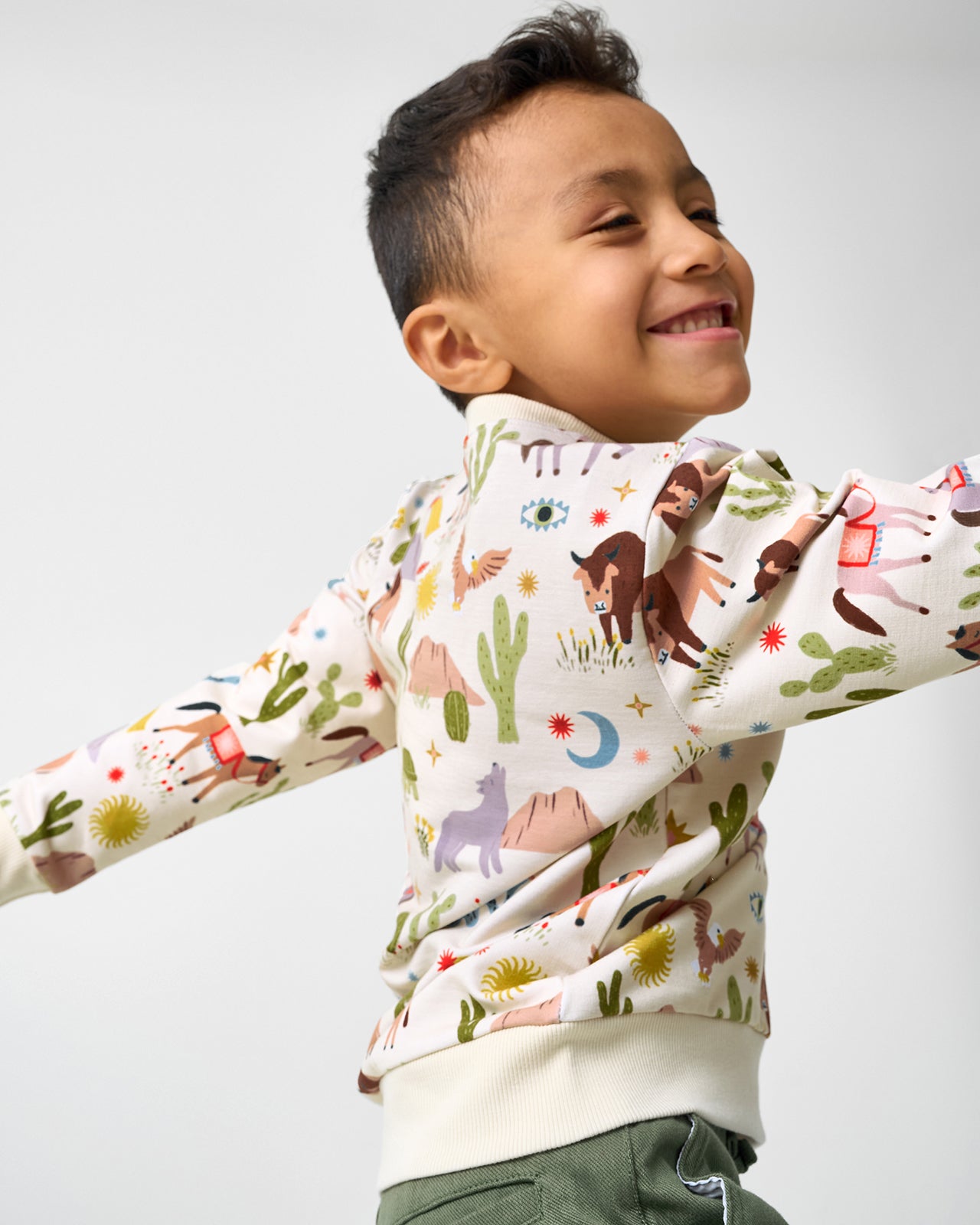 Boy in motion wearing the Wild Frontier Crewneck Sweatshirt