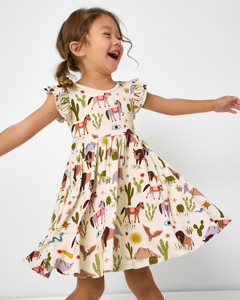 Twirling girl wearing the Wild Frontier Flutter Twirl Dress