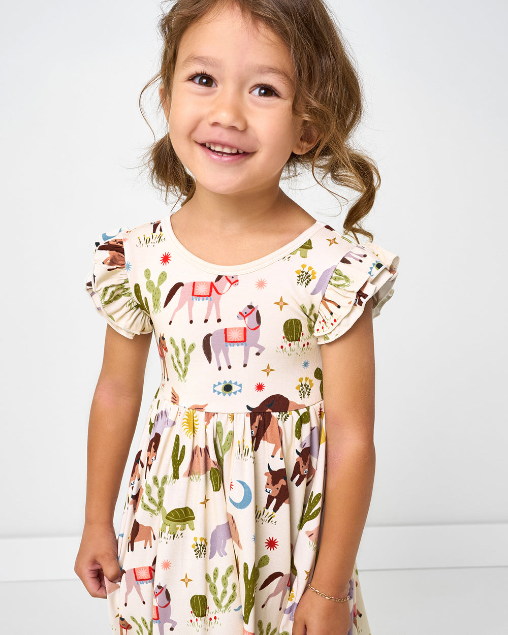Close up of girl wearing the Wild Frontier Flutter Twirl Dress