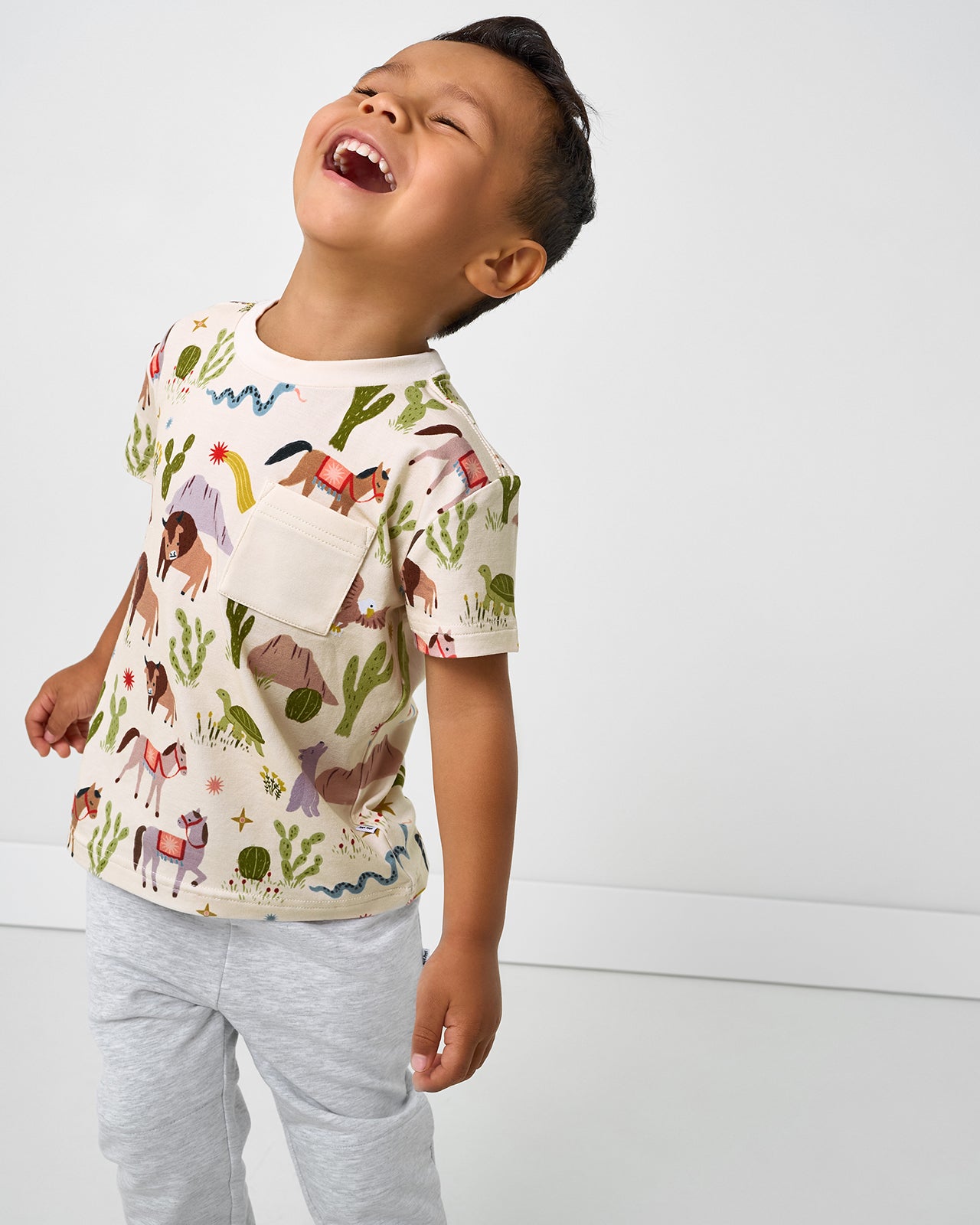 Boy wearing the Wild Frontier Relaxed Pocket Tee with gray boys joggers