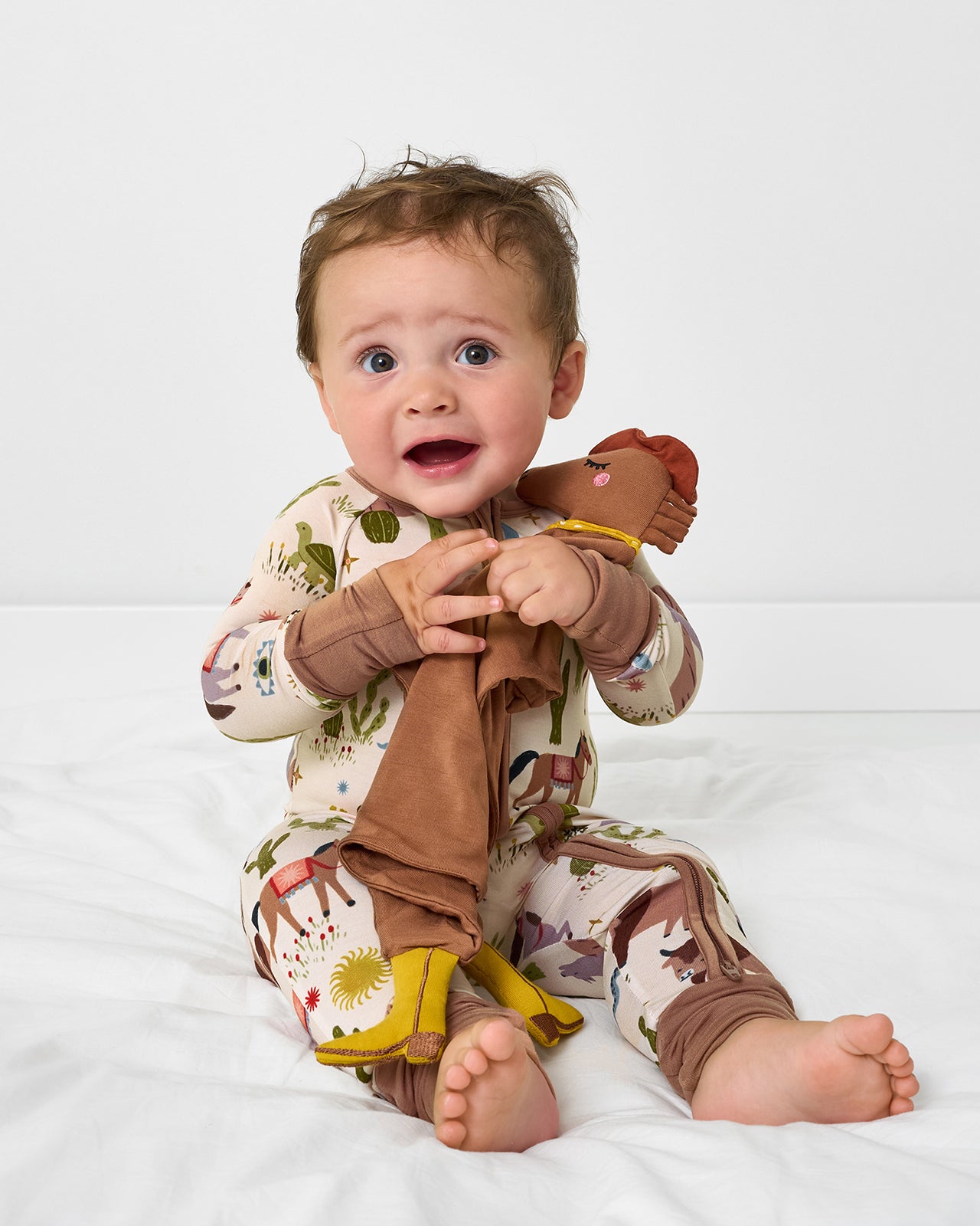 Baby holding the Harley the Horse Sleepyhead Lovey
