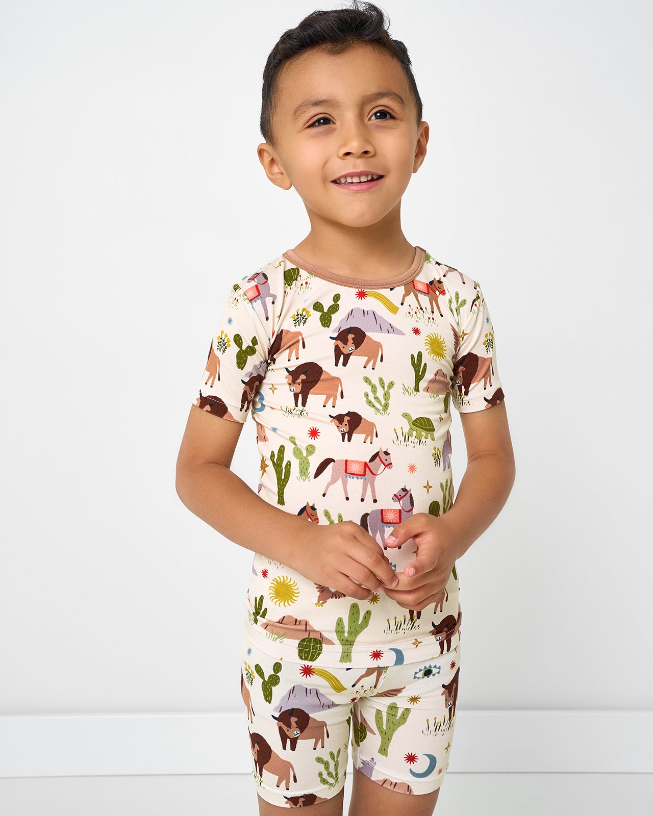 Boy wearing the Wild Frontier Two-Piece Short Sleeve & Shorts Pajama Set