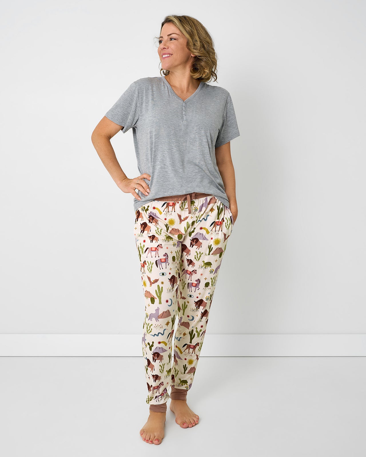 Woman wearing the Wild Frontier Women's Pajama Pants with a gray pajama top