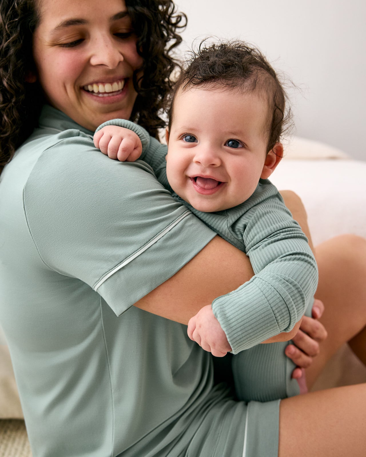 Mother holding baby wearing matching Willow pajamas
