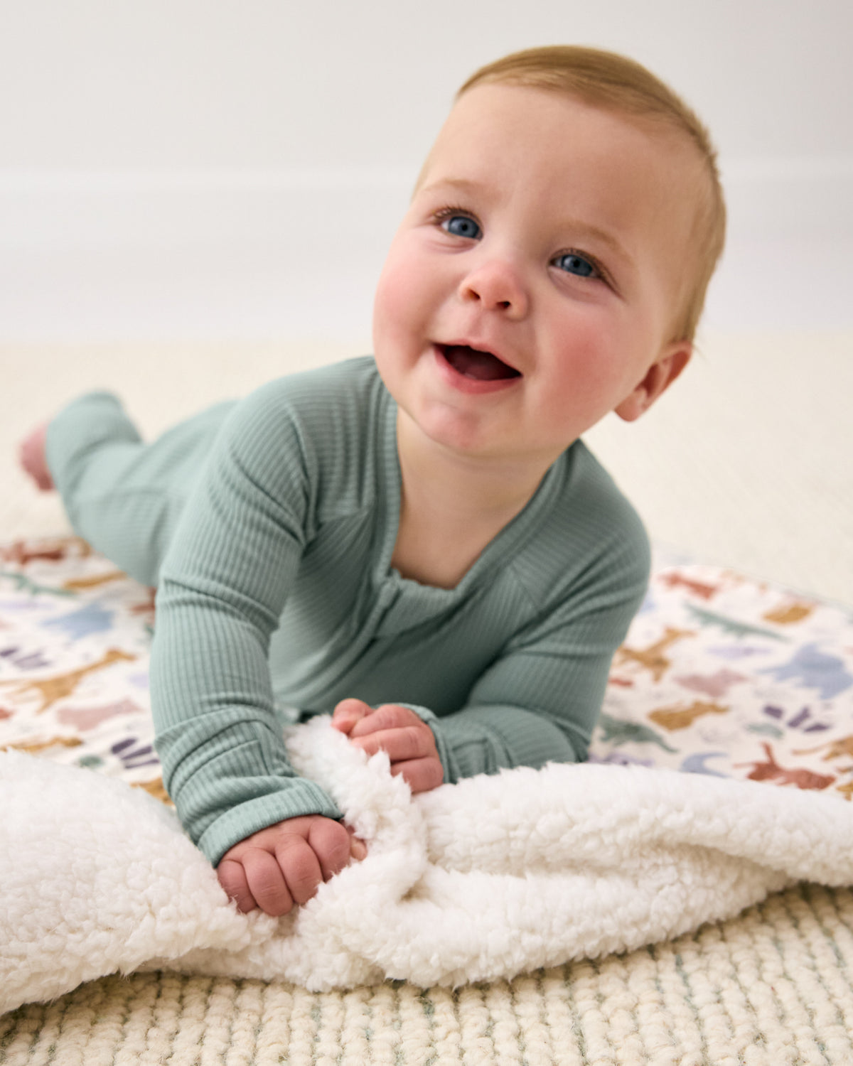 Newborn laying on the Sweet Safari Mini Cloud Blanket
