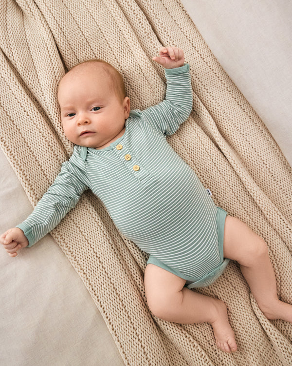 Aerial view of newborn wearing the Willow Stripe Henley Bodysuit