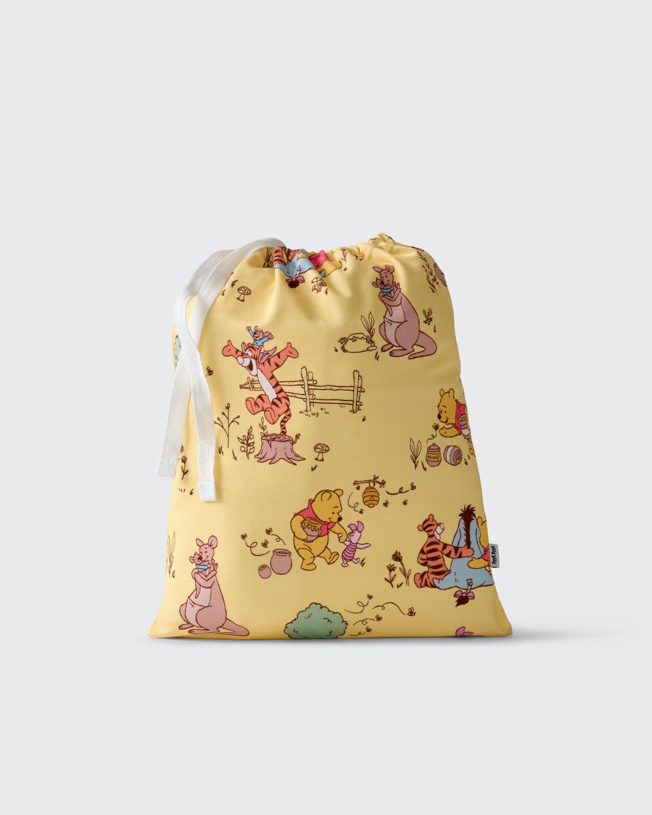 Flat lay of the Disney Sweet As Can Bee Fitted Crib Sheet drawstring bag