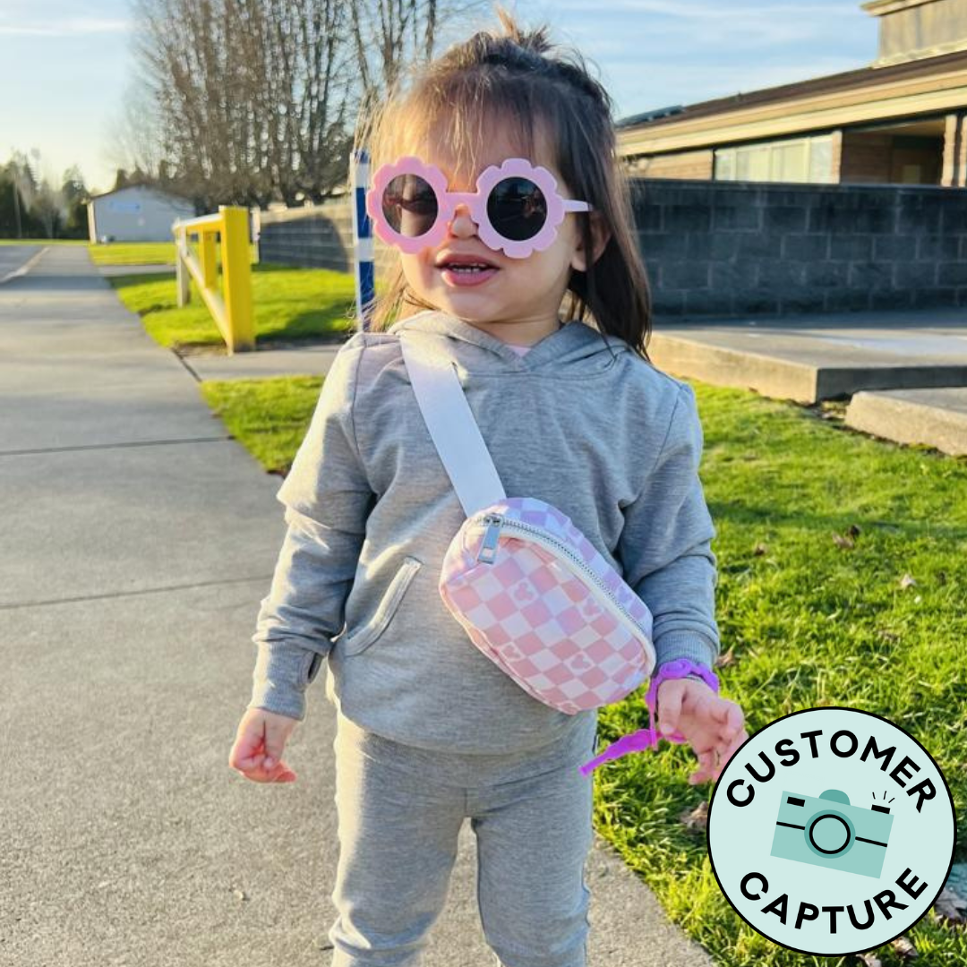 Customer Capture image of a child wearing a Heather Gray pullover hoodie paired with Heather Gray cozy leggings