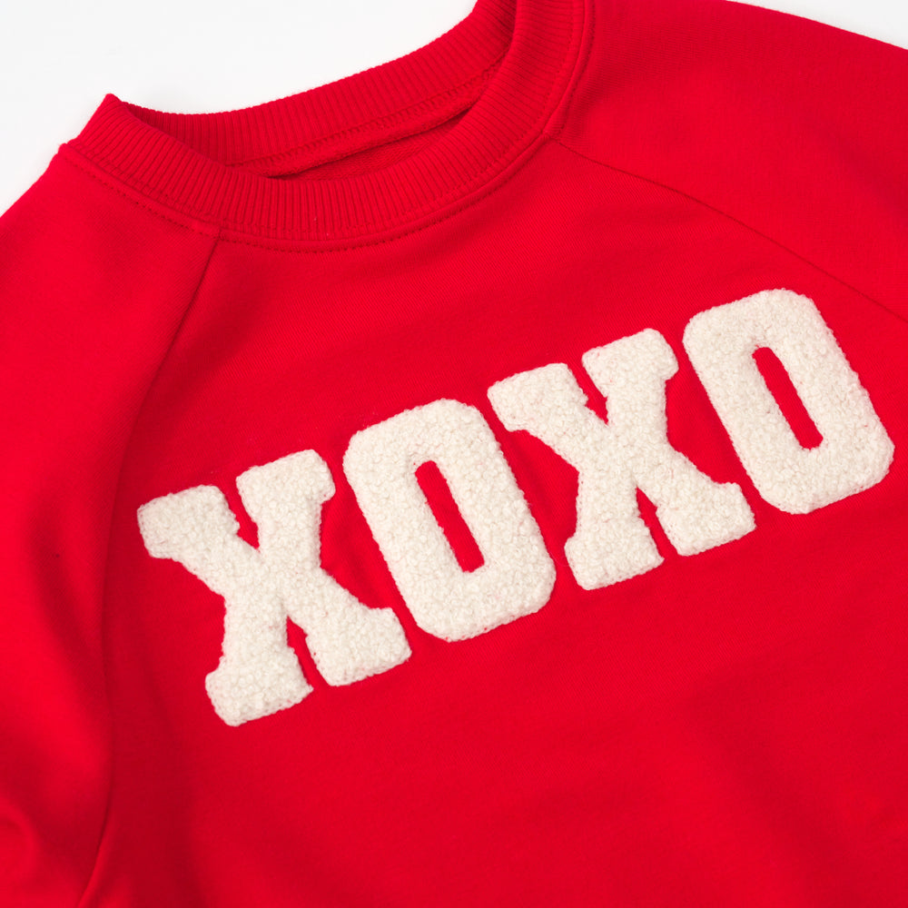 close up flat lay of an XOXO crewneck sweatshirt