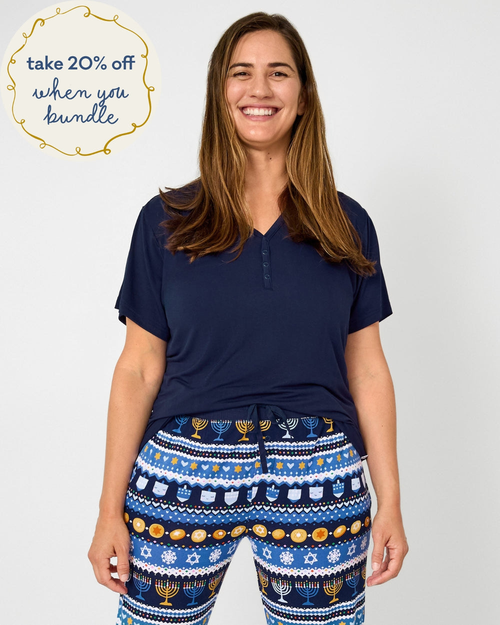 Woman wearing short sleeve classic navy women's pajama top paired with Hanukkah Fair Isle women's pajama pants.