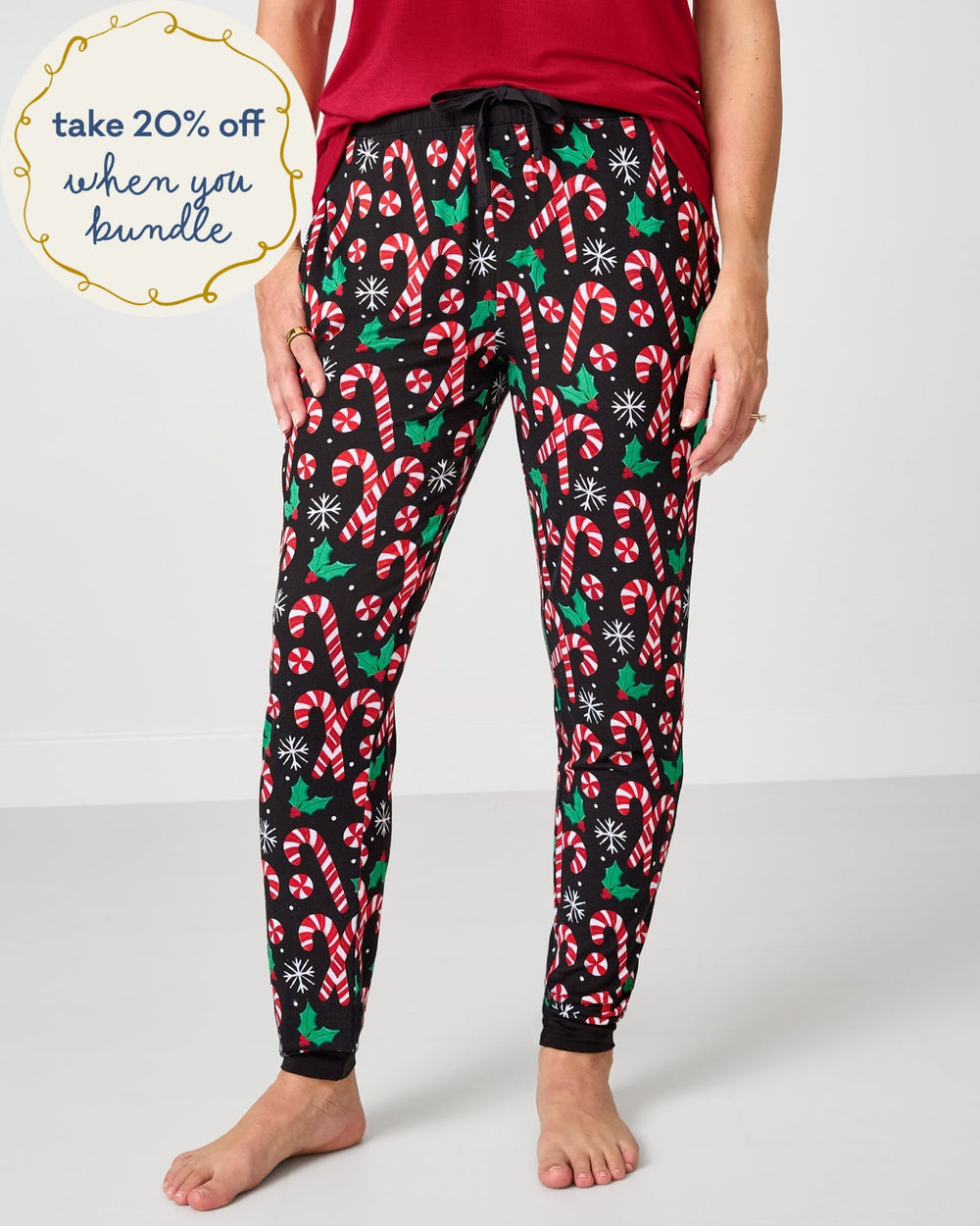 Woman wearing the Merry Mints Women's Pajama Pants with a red pajama top