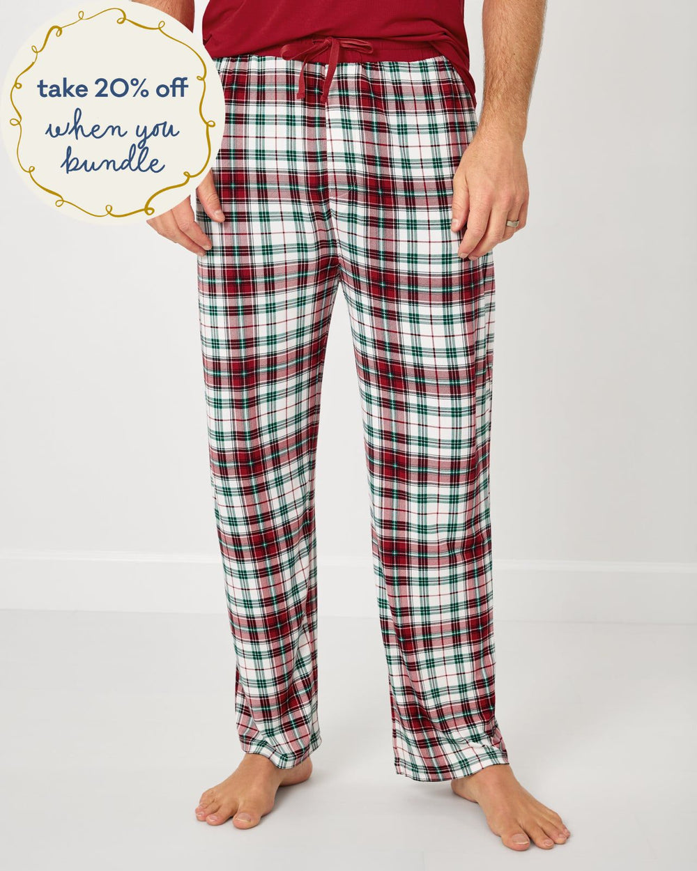 Man wearing the Holly Plaid Men's Pajama Pants with a red pajama top