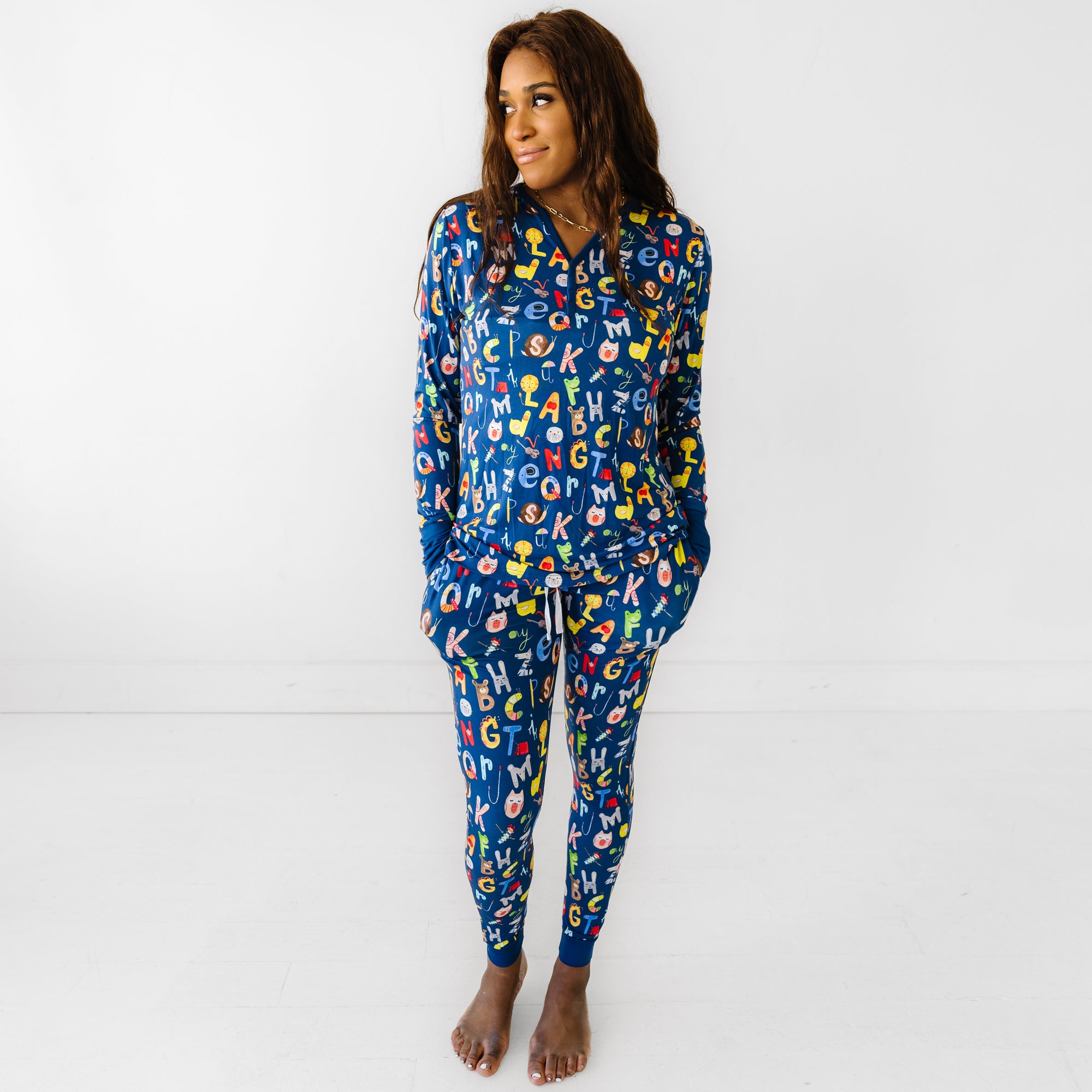 Woman wearing Alphabet Friends women's pajama top and matching pajama pants