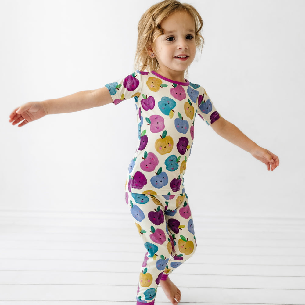 Child jumping wearing a Berry Apple of my Eye two piece short sleeve pajama set
