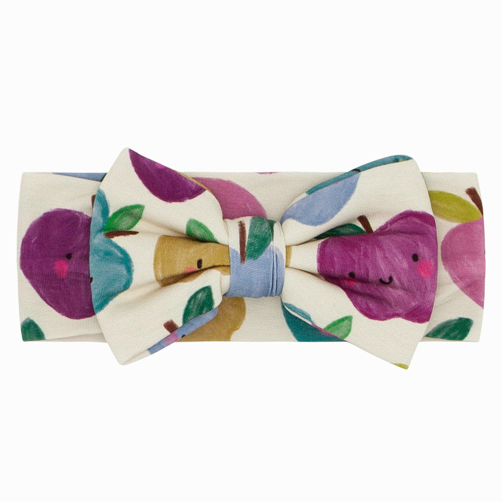 Click to see full screen - Flat lay image of a Berry Apple of my Eye luxe bow headband