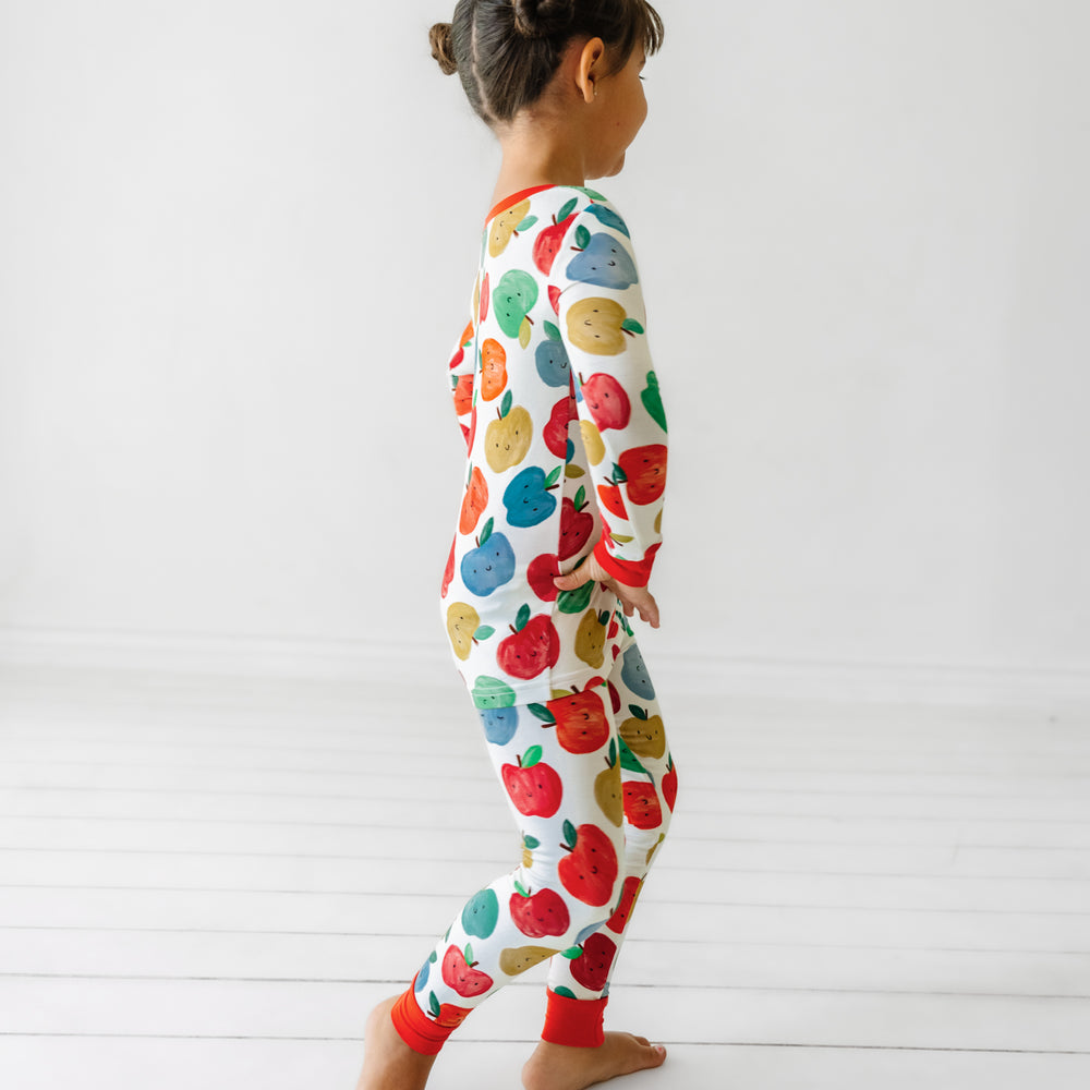 Side view image of a child wearing a Red Apple of My Eye two piece pajama set