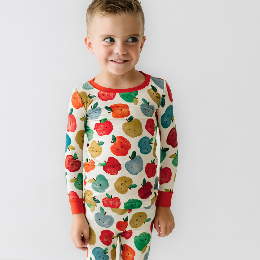 Close up image of a child wearing a Red Apple of My Eye two piece pajama set