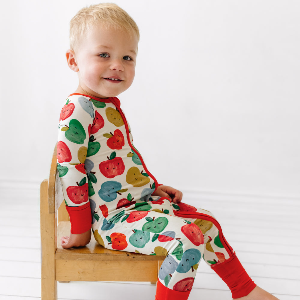 Click to see full screen - Alternate image of a child sitting on a chair wearing a Red Apple of My Eye zippy