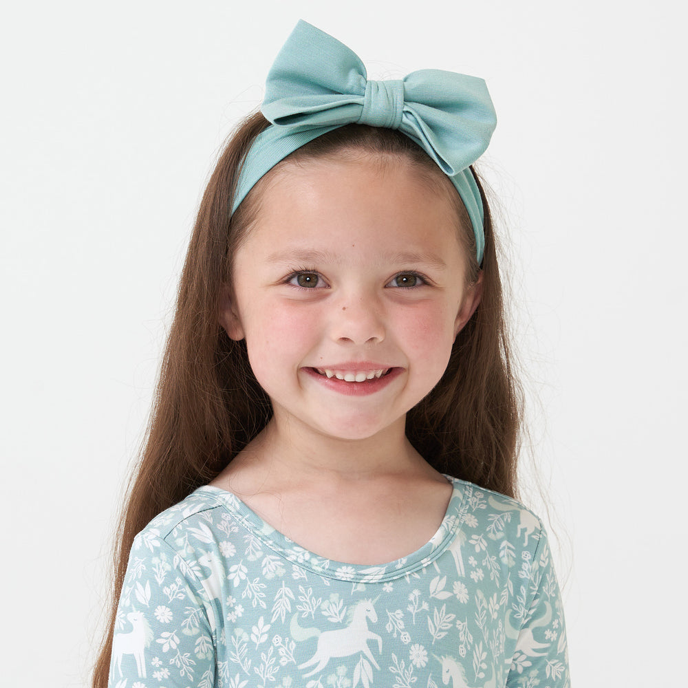 Child wearing an Aqua Mist luxe bow headband