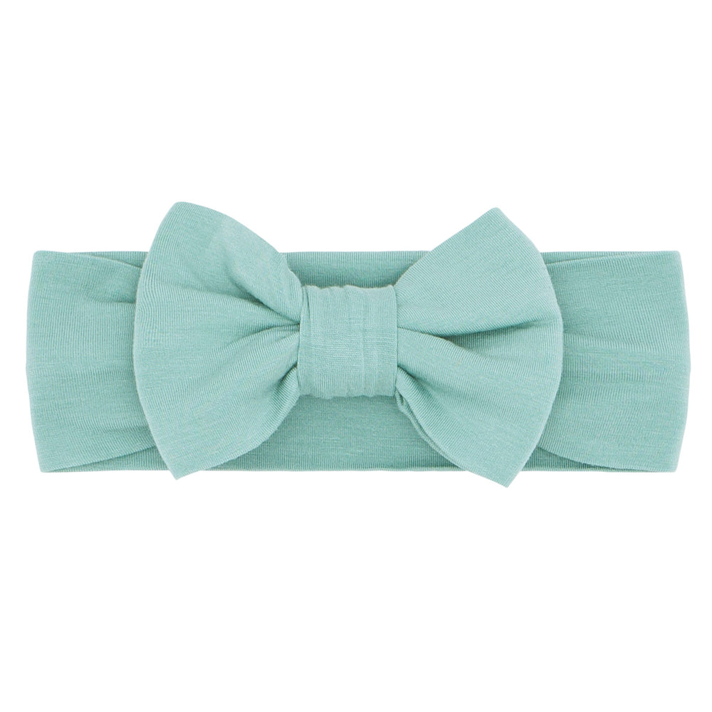 Flat lay image of an Aqua Mist luxe bow headband in size Newborn to age 3
