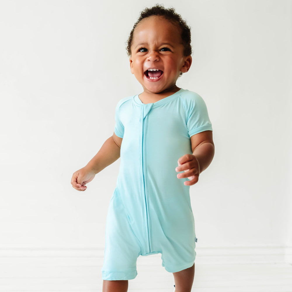 Close up of a child wearing an Aquamarine shorty romper