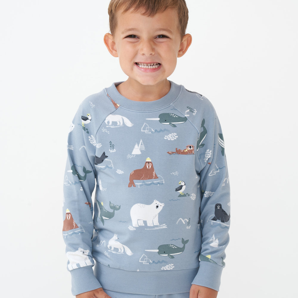 Alternate close up image of a child wearing an Arctic Animals printed crewneck sweatshirt