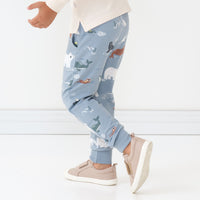 Close up side view image of a child wearing Arctic Animals printed joggers