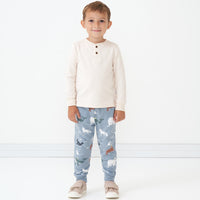 Child wearing Arctic Animals printed joggers and coordinating henley tee