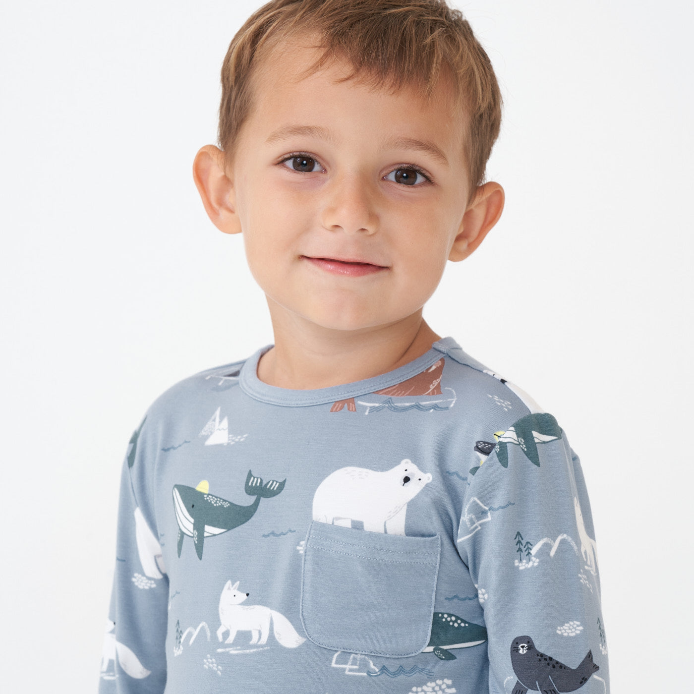 Close up image of a child wearing an Arctic Animals printed pocket tee