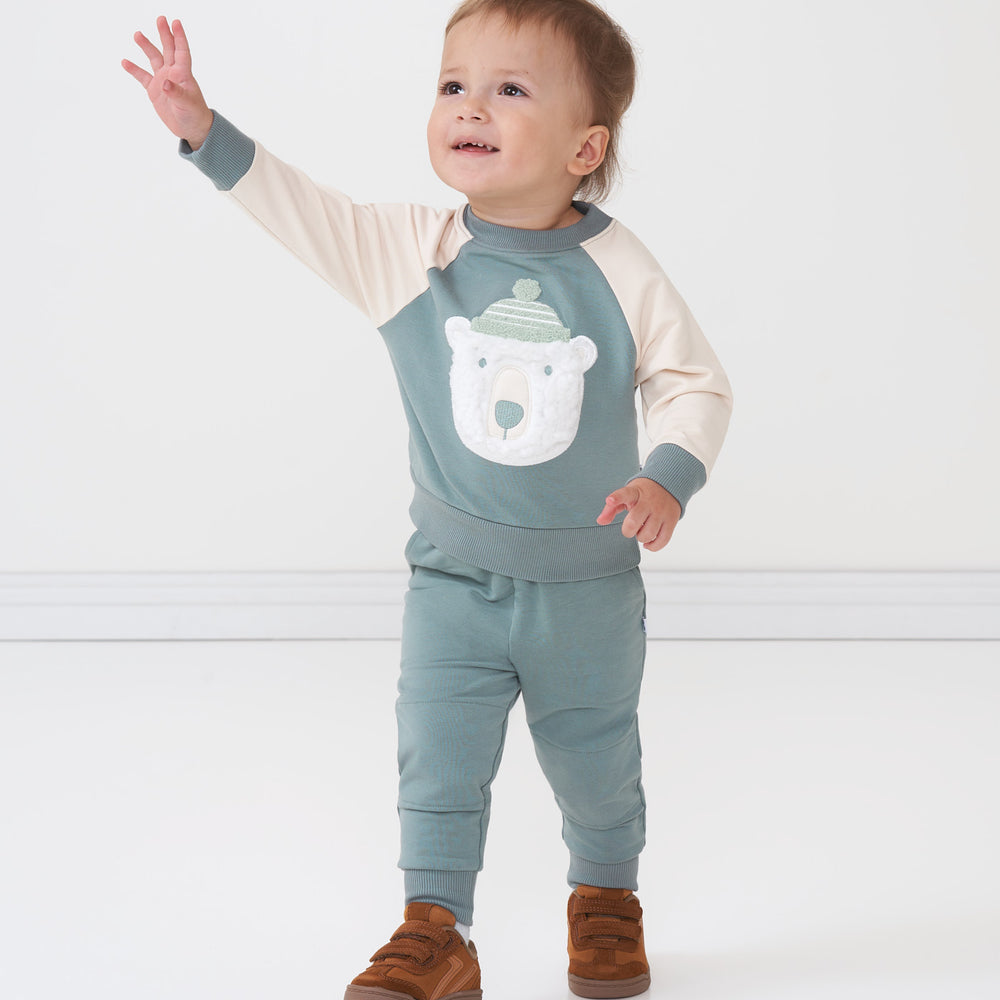 Child wearing a Polar Bear crewneck sweatshirt and coordinating Vintage Teal joggers