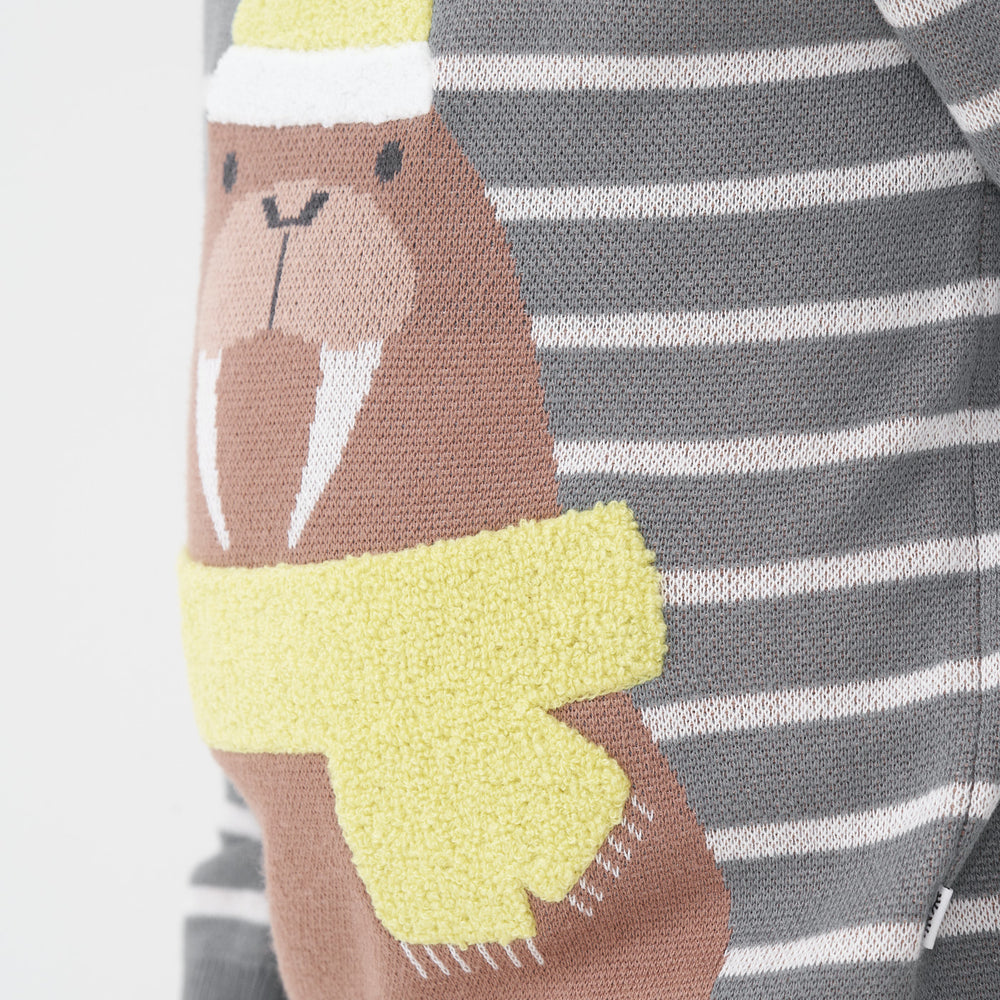 Close up detail image of a Walrus knit sweater