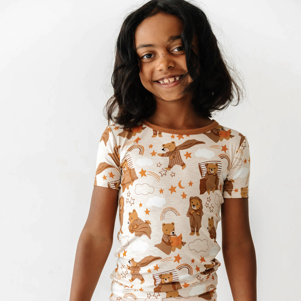 Close up of a smiling child wearing a Beary Sleepy Two-Piece Short Sleeve Pajama Set