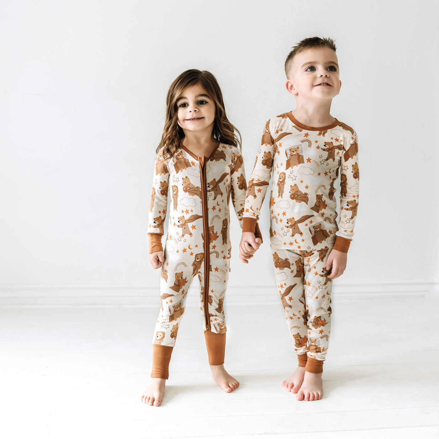 Two children wearing matching Beary Sleepy pajamas