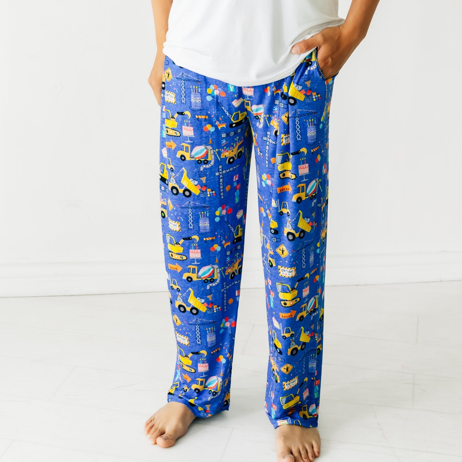 Close up view of a man wearing Birthday Builders Men's Pajama Pants and a Bright White Men's Pajama Top