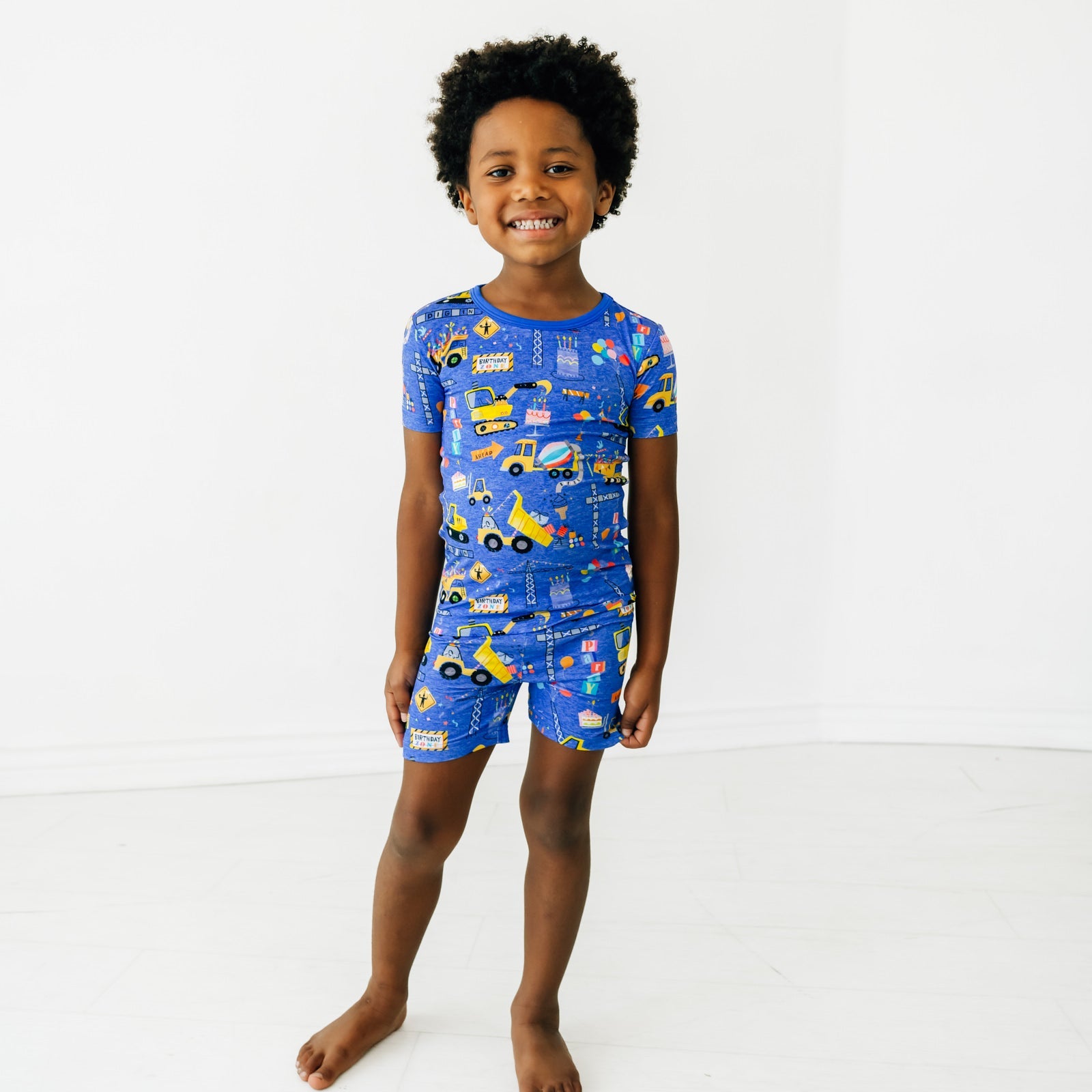 Child wearing a Birthday Builders Two-Piece Short Sleeve and Shorts Pajama Set