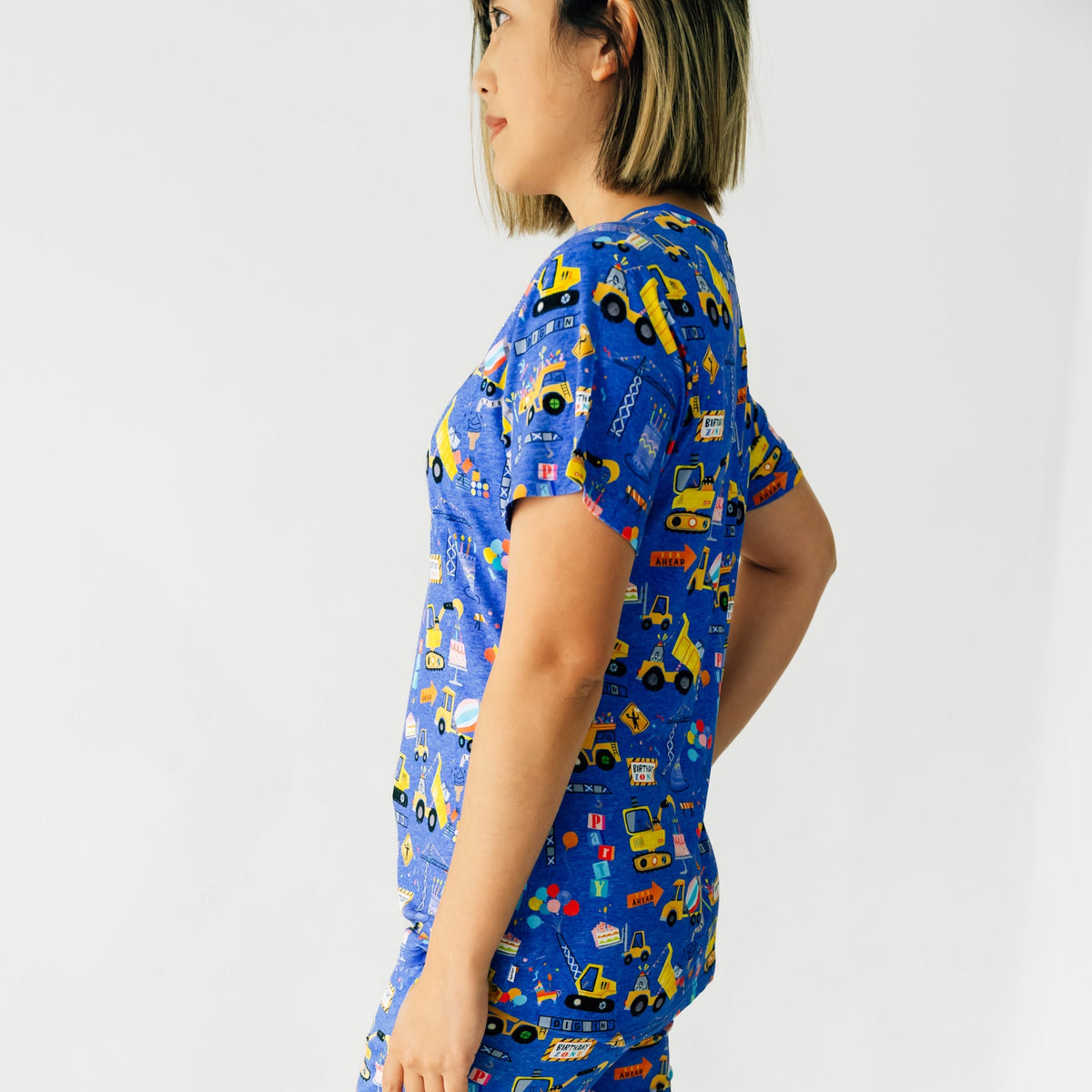Close up profile view of a woman wearing a Birthday Builders Women's Pajama Top