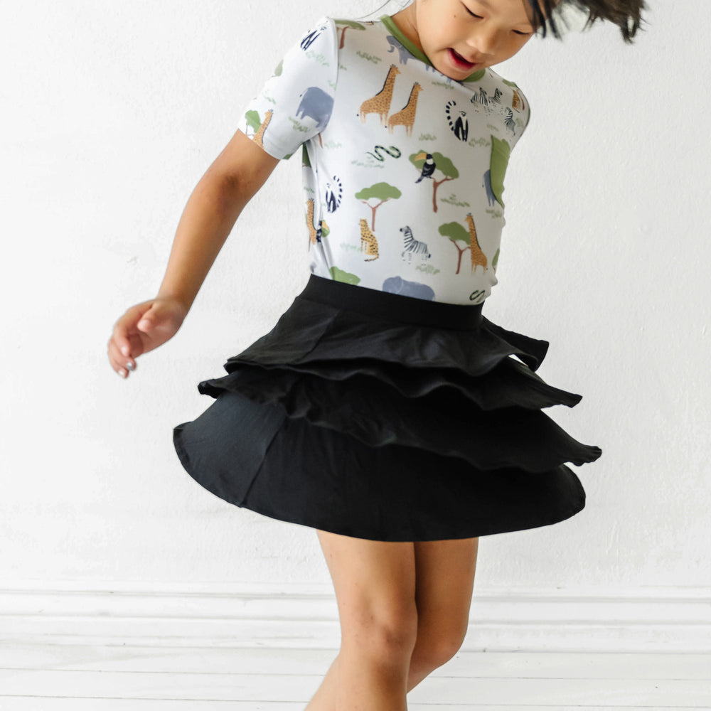 Child spinning wearing a Black ruffle skort