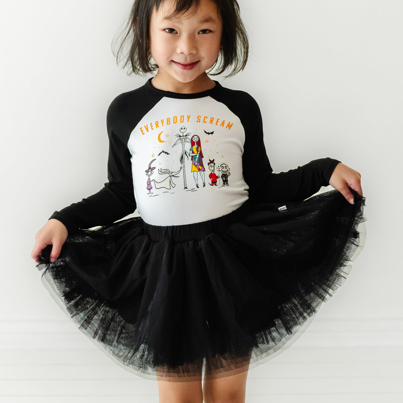 Child posing wearing a Nightmare Before Christmas graphic tee paired with a Black bamboo viscose lined tutu