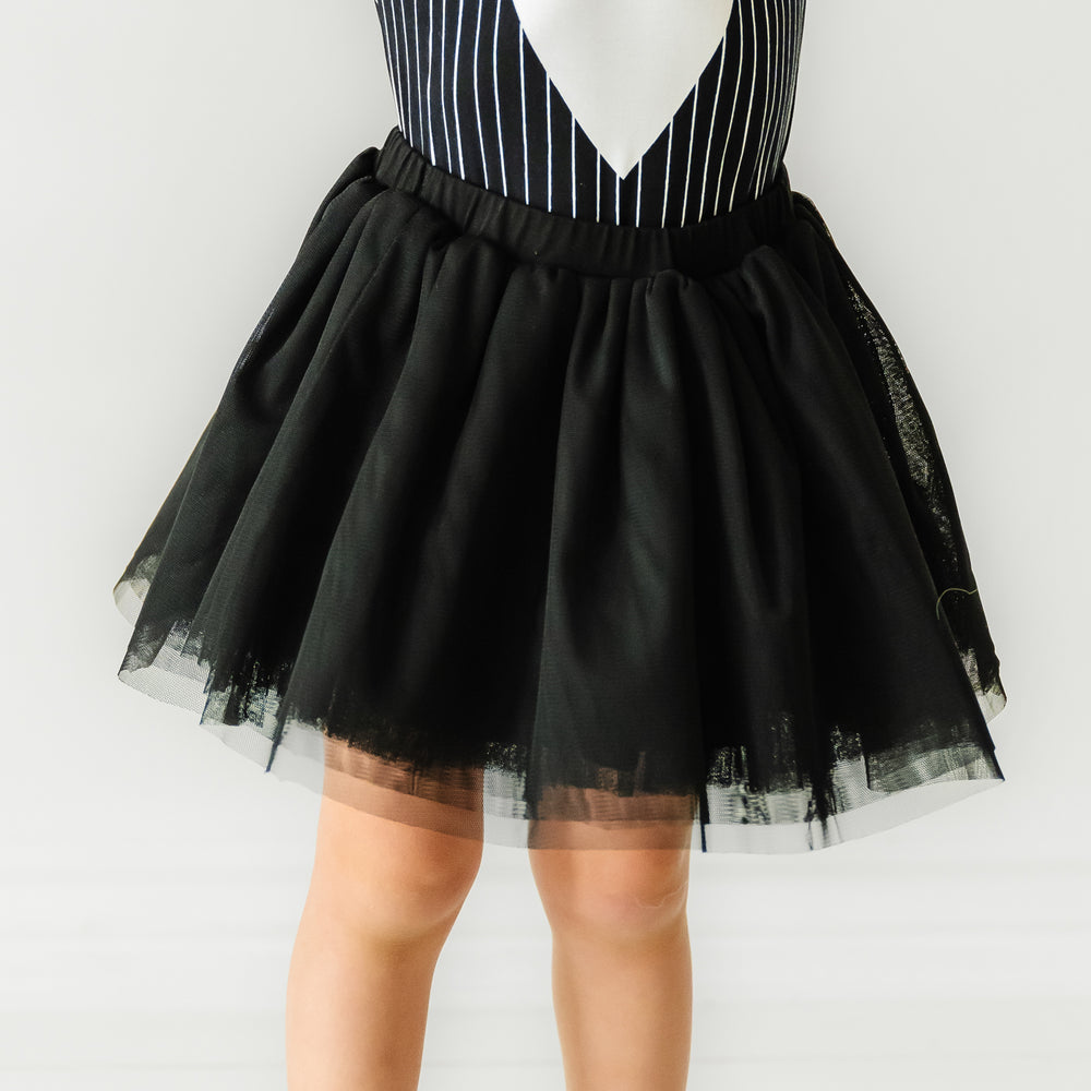 Child posing wearing a Jack Skellington graphic bodysuit paired with a Black bamboo viscose lined tutu