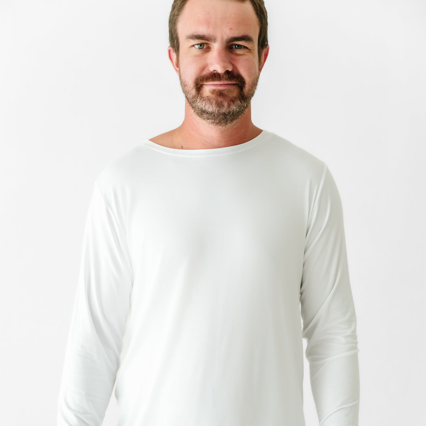 Close up image of a man wearing a Bright White men's pajama top