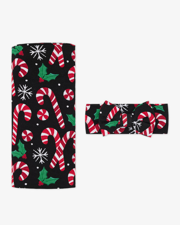 Flat lay of the Merry Mints Swaddle & Luxe Bow Headband Set