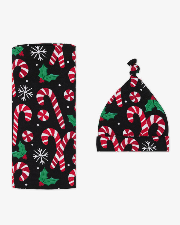 Flat lay of the Merry Mints Swaddle & Hat Set