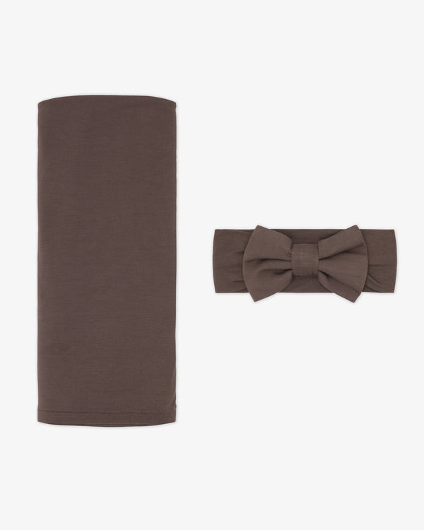 Flat lay of the Dark Chocolate Swaddle & Luxe Bow Headband Set