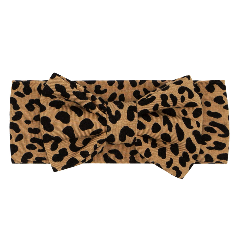 Flat lay image of a Classic Leopard printed luxe bow headband