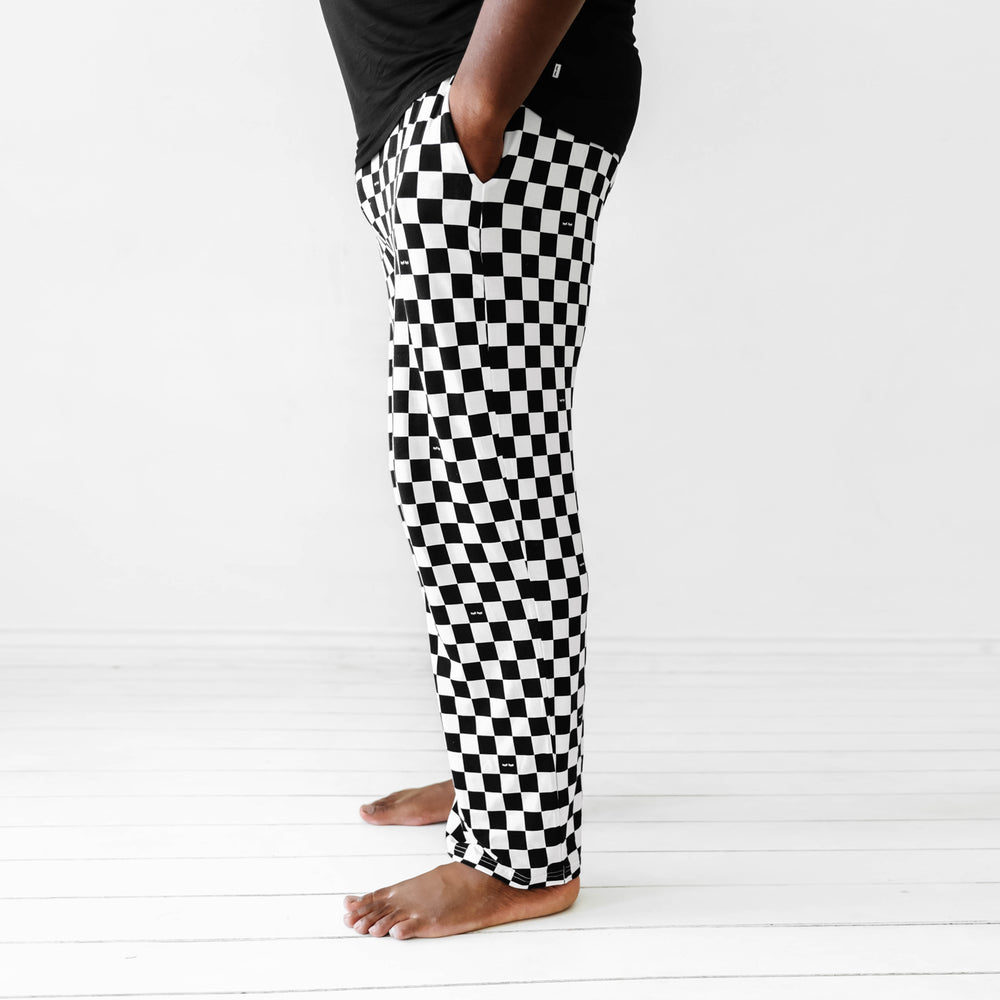 Click to see full screen - Close up profile view image of a man wearing Cool Checks printed men's pajama pants with his hands in his pockets